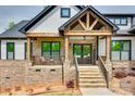 Inviting stone-clad front porch with wooden beams and a cozy seating area, leading to the entrance at 1336 W Rebound Rd, Indian Land, SC 29720