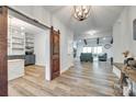 Open living area with wood floors, sliding barn door, and seamless transition to other rooms at 1336 W Rebound Rd, Indian Land, SC 29720