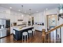 Bright kitchen featuring white cabinetry, a marble island with seating, and stainless steel appliances at 1358 Cedardale Ln, Denver, NC 28037