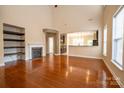 Bright living room featuring gleaming hardwood floors, fireplace, and ample natural light at 13936 Mallard Lake Rd, Charlotte, NC 28262