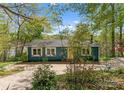 Quaint home with vibrant yellow front door and beautiful surrounding greenery at 1430 Mollys Backbone Rd, Catawba, NC 28609