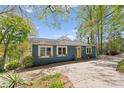 Charming waterfront home featuring a bright yellow door and mature trees at 1430 Mollys Backbone Rd, Catawba, NC 28609