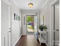 Bright foyer featuring hardwood floors, a white console table, and an open doorway to the outside at 1506 Crestdale Rd, Rock Hill, SC 29732