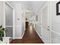 Long hallway with hardwood floors, white trim, and multiple doorways leading to various rooms at 1506 Crestdale Rd, Rock Hill, SC 29732