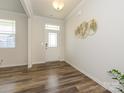 Bright foyer featuring wood-look floors and an elegant decorative wall piece creating a welcoming atmosphere at 1516 Laggan Ln, Indian Trail, NC 28079