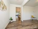 Spacious living room with wood-look floors, neutral walls, and seamless flow to the dining and kitchen areas at 1516 Laggan Ln, Indian Trail, NC 28079