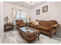 Cozy living room features decorative fireplace, chandelier lighting and light airy decor at 16219 Long Talon Way, Charlotte, NC 28273