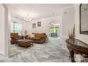 Elegant living room featuring tile floors, classic furnishings, and abundant natural light at 16219 Long Talon Way, Charlotte, NC 28273