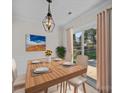 Dining area featuring wood table, chandelier, and sliding glass door to the backyard at 1762 Tate Rd, Rock Hill, SC 29732