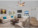 Bright living room with a fireplace, hardwood floors, and large windows at 1762 Tate Rd, Rock Hill, SC 29732