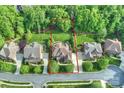 Aerial view of a private residence with manicured lawns and surrounded by mature trees at 2001 Arundale Ln, Matthews, NC 28104