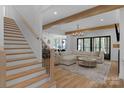 Bright, open living room features wood floors, a neutral sectional sofa, and a modern chandelier at 2165 Country Club Rd, Lincolnton, NC 28092