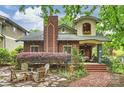 Inviting front yard with a brick walkway, cozy seating area, and lush landscaping, perfect for outdoor entertaining and relaxation at 2229 Kenmore Ave, Charlotte, NC 28204