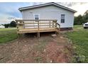 A newly constructed wooden deck on the back of the house offers a nice outdoor space at 234 Olin Loop, Olin, NC 28660