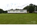 Expansive backyard features well-maintained lawn and a view of the home's rear exterior at 234 Olin Loop, Olin, NC 28660