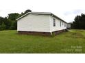 Exterior view of the home showing vinyl siding and brick foundation at 234 Olin Loop, Olin, NC 28660