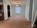 The living room features a neutral-toned carpet and bright lighting at 234 Olin Loop, Olin, NC 28660