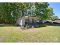 Inviting one-story home featuring a cozy front porch with manicured landscaping and partial driveway at 315 N Kimmons St, Landis, NC 28088