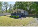 A charming single-story home with a covered front porch, complemented by a neatly maintained lawn at 315 N Kimmons St, Landis, NC 28088