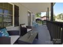 Inviting front porch featuring cozy seating, stylish decor, and shaded comfort at 315 N Kimmons St, Landis, NC 28088
