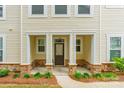 Inviting front porch with stone pillars and manicured landscaping, offers a welcoming entrance at 3832 Amalia Pl, Indian Land, SC 29707
