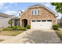 Charming single-Gathering home featuring a stone facade and well-maintained landscaping at 4019 Channel Islands Way, Lancaster, SC 29720