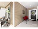 Inviting covered front porch with seating, a wreath on the front door, and neutral siding at 4019 Channel Islands Way, Lancaster, SC 29720