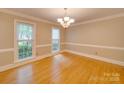 Elegant dining room with hardwood floors, neutral walls, chandelier, and natural light at 5412 Crosshill Ct, Charlotte, NC 28277