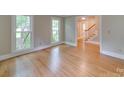 Bright living room featuring hardwood floors, large windows, and neutral wall colors at 5412 Crosshill Ct, Charlotte, NC 28277