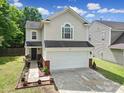 Inviting home with a two-car garage, well-maintained lawn, brick accents, and charming curb appeal at 5524 Wyalong Dr, Charlotte, NC 28227