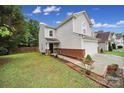 Inviting home with a two-car garage, well-maintained lawn, brick accents, and charming curb appeal at 5524 Wyalong Dr, Charlotte, NC 28227