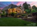 Beautiful home featuring a screened porch, open deck, and lush backyard with mature landscaping at 5809 Woodleigh Oaks Dr, Charlotte, NC 28226
