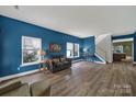 Bright living room featuring hardwood floors, large windows and neutral colored furniture at 656 Hosta Dr, Fort Mill, SC 29715