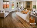Bright living room featuring a stone fireplace, hardwood floors, and modern furnishings at 8026 Regent Park Ln, Charlotte, NC 28210