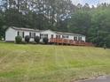Well-maintained single story home with a wheelchair ramp and lush green lawn at 8813 Summerhill Dr, Waxhaw, NC 28173
