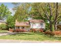 Charming home with mature trees and landscaping, featuring a well-maintained lawn and inviting entrance at 1114 Hartford Ave, Charlotte, NC 28209