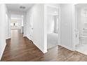 Open-concept hallway with wood flooring leading to a bathroom and carpeted bedrooms at 1135 Foxberry Ln, Maiden, NC 28650