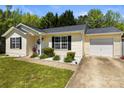Inviting one-story home with a well-maintained lawn, attached garage, and classic curb appeal at 119 Sweet Martha Dr, Mooresville, NC 28115