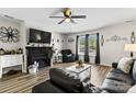 Stylish living room with a fireplace, TV, dark furniture, and contemporary decor at 119 Sweet Martha Dr, Mooresville, NC 28115