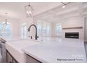 Bright kitchen showcasing a large island with marble countertops, farmhouse sink, and stainless steel appliances at 122 Huntcliff Dr, Statesville, NC 28677