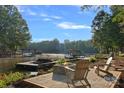 Picturesque lakefront property with private dock, cozy seating area, and tranquil water views under a sunny sky at 127 Holt Ln, Mooresville, NC 28117