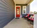 Inviting covered front porch featuring rocking chairs and charming decor, creating a cozy outdoor space at 13702 Jacks Ln, Pineville, NC 28134