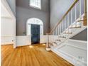 Bright foyer showcasing beautiful hardwood floors, staircase, and arched entryways, creating a welcoming ambiance at 15618 Eagleview Dr, Charlotte, NC 28278