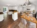 Bright, open-concept living room and kitchen area with hardwood floors, stylish lighting, and modern decor at 1625 Winthrop Ln, Monroe, NC 28110