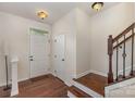 Inviting home foyer featuring hardwood floors, stairs, and natural light at 1720 Fleetwood Dr, Charlotte, NC 28208