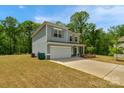 Attractive two-story home with a well-kept lawn and a practical two-car garage at 197 Park View Dr, Stanfield, NC 28163