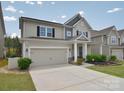 Well-maintained two-story home featuring a two-car garage and a neatly landscaped front yard at 2014 Burton Point Ct, Waxhaw, NC 28173