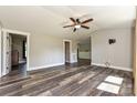Spacious living room featuring wood floors, a ceiling fan, and ample natural light at 202 Hickory St, Locust, NC 28097