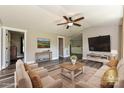 Cozy living room with neutral colors, updated flooring, contemporary furnishings, and recessed lighting at 202 Hickory St, Locust, NC 28097