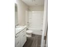 Full bathroom with tub/shower combo, granite vanity, modern fixtures, and luxury vinyl plank flooring at 206 N Kayla Dr, Salisbury, NC 28146